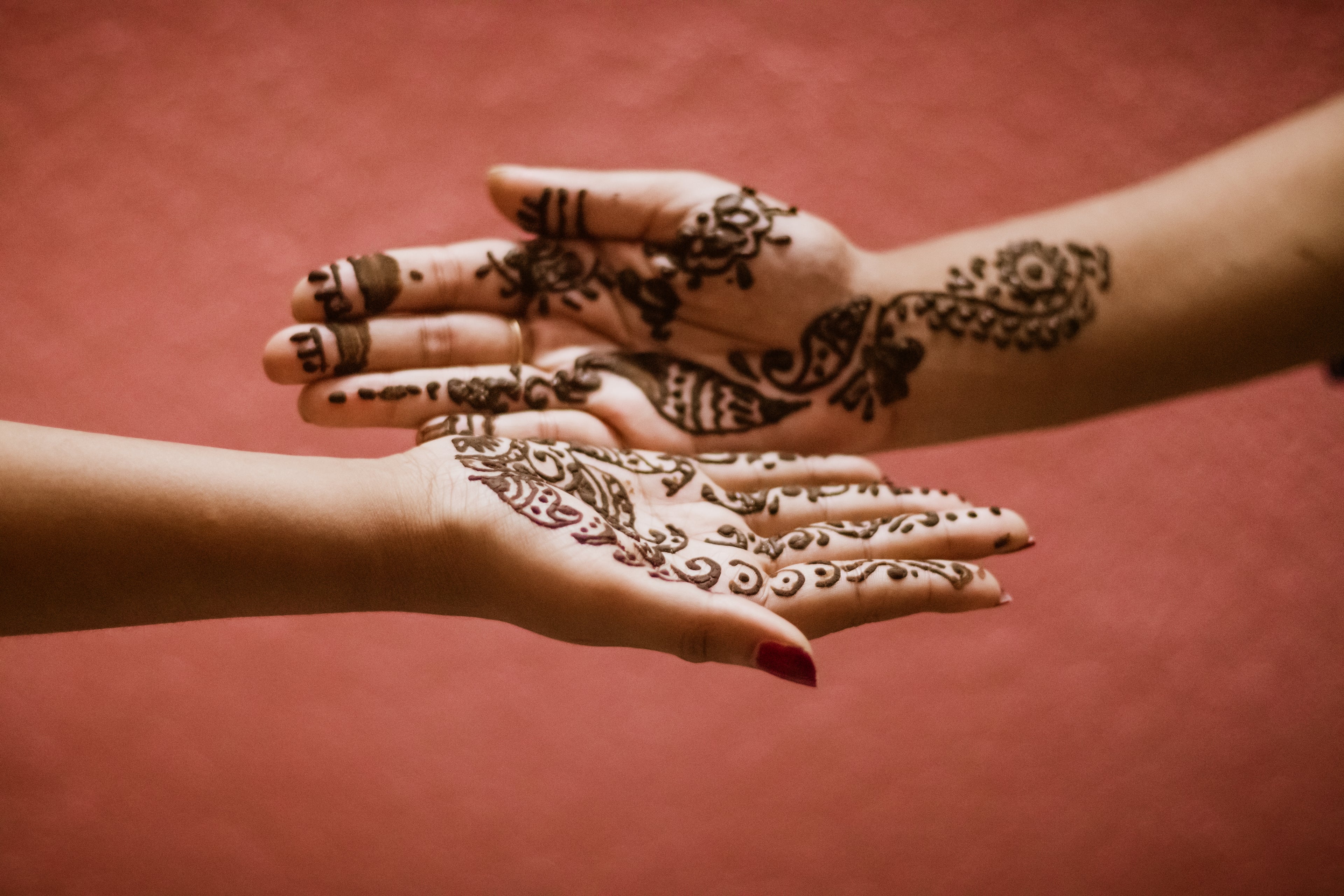 Intricate traditional South Asian henna mehndi design on hands showcasing womens cultural streetwear fashion branding.